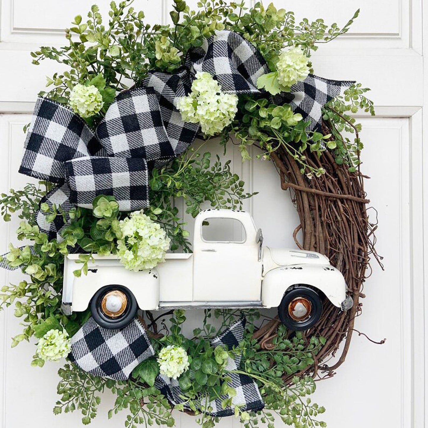 White Truck Wreath with Black and White Ribbon and Seasonal Flower Accents